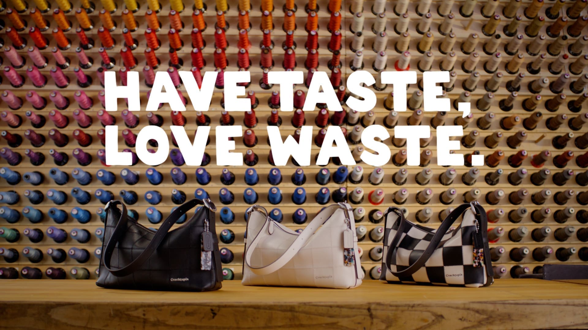 RIOT, NYC Creative Agency: Three Coachtopia Alter/Ego bags in different colors, displayed in front of a colorful thread wall with the words ‘Have Taste, Love Waste.’ Three Coachtopia Alter/Ego bags in different colors, displayed in front of a colorful thread wall with the words ‘Have Taste, Love Waste.’