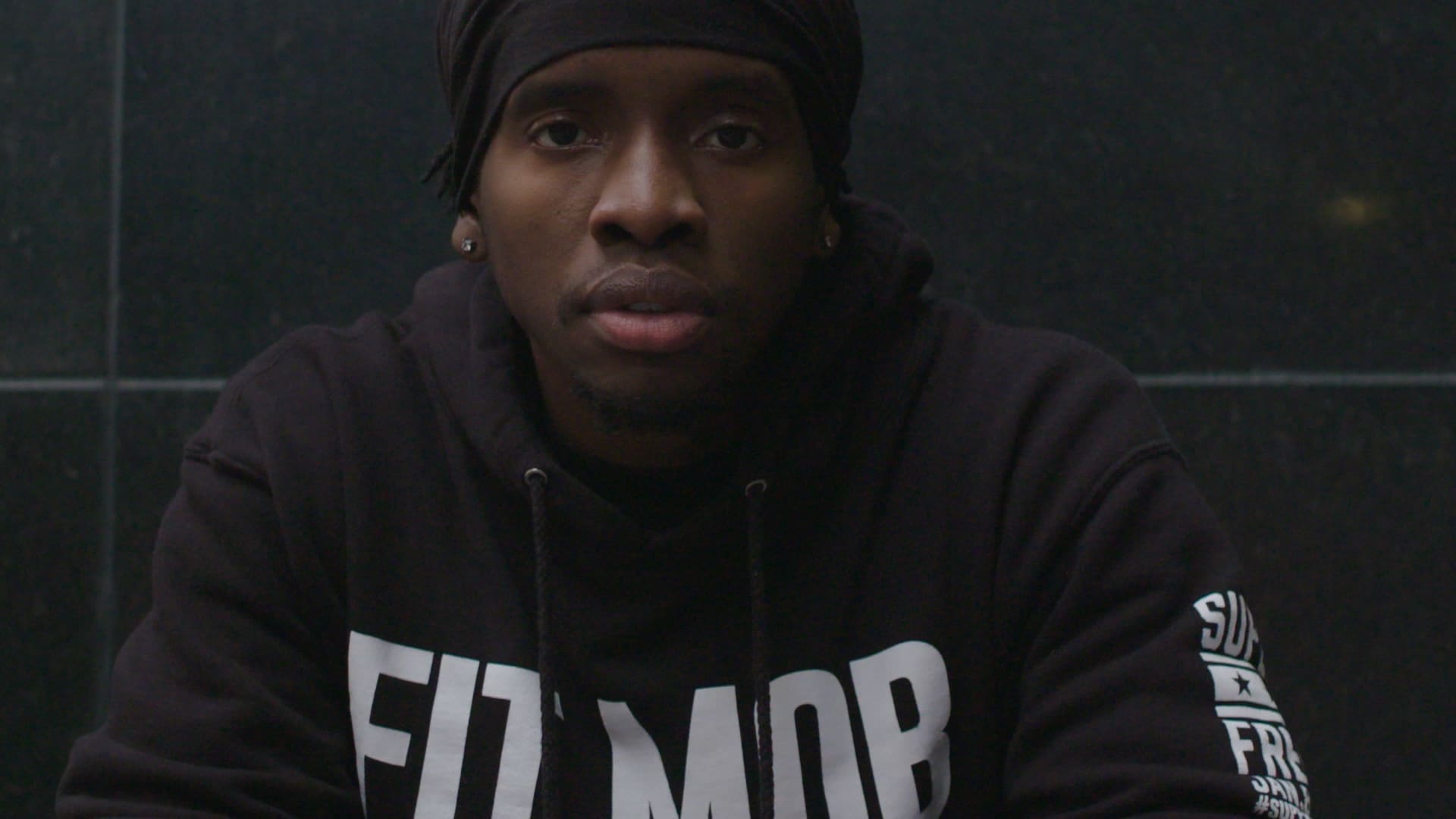 RIOT, NYC Creative Agency: Close-up of Trammell, a SoulCycle instructor, reflecting on his journey in a dark setting Close-up of Trammell, a SoulCycle instructor, reflecting on his journey in a dark setting
