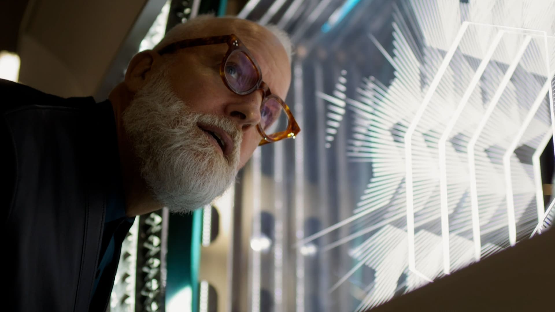 Christopher Young, Tiffany's VP Creative Director, intently observing the intricate holiday window display, highlighting a fusion of light and craftsmanship.