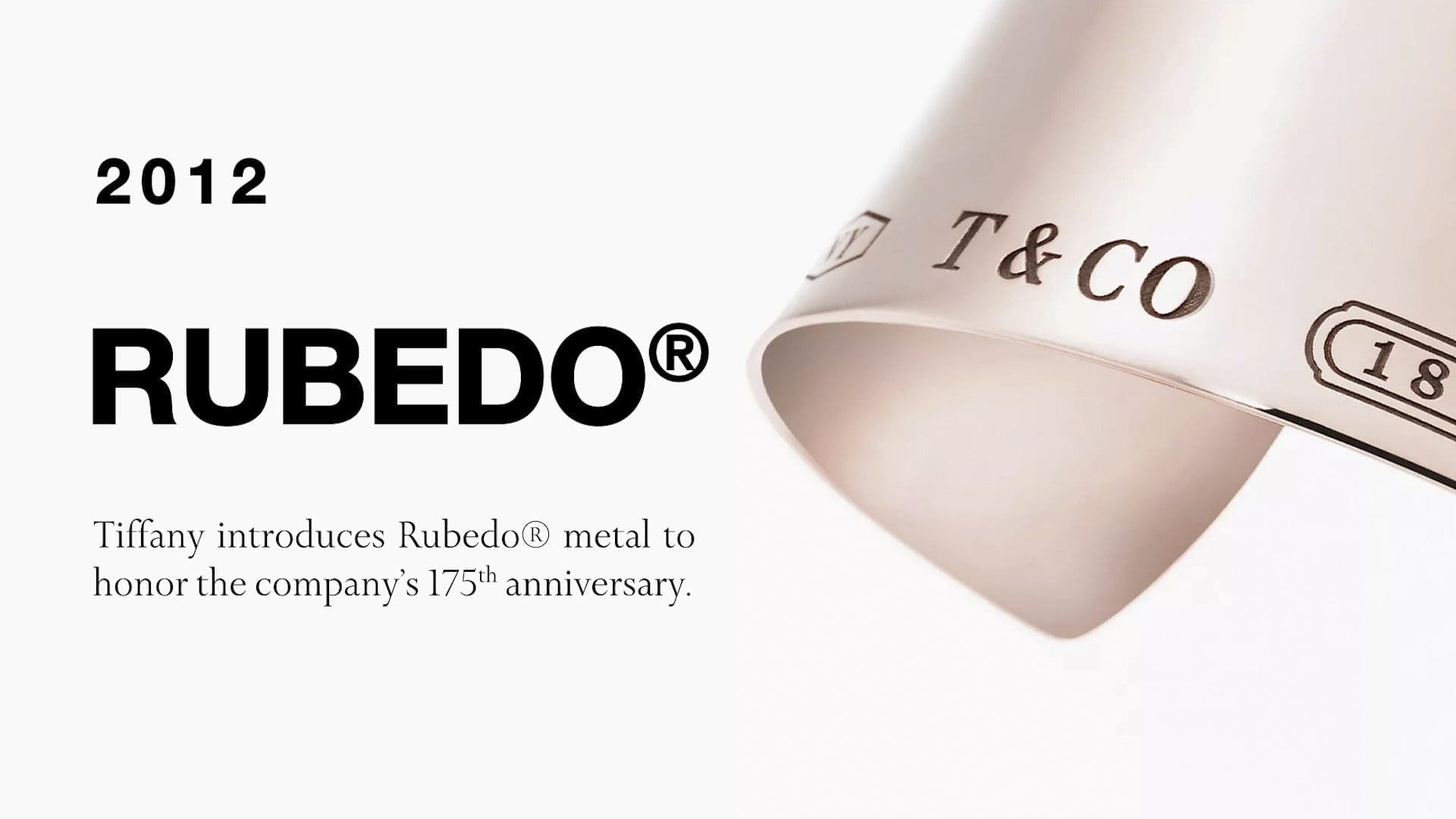 RIOT, NYC Creative Agency: Promotional image for Tiffany & Co. from 2012, announcing the introduction of Rubedo® metal in honor of the company's 175th anniversary, featuring a curved sheet of the metal with Tiffany's branding. Promotional image for Tiffany & Co. from 2012, announcing the introduction of Rubedo® metal in honor of the company's 175th anniversary, featuring a curved sheet of the metal with Tiffany's branding.