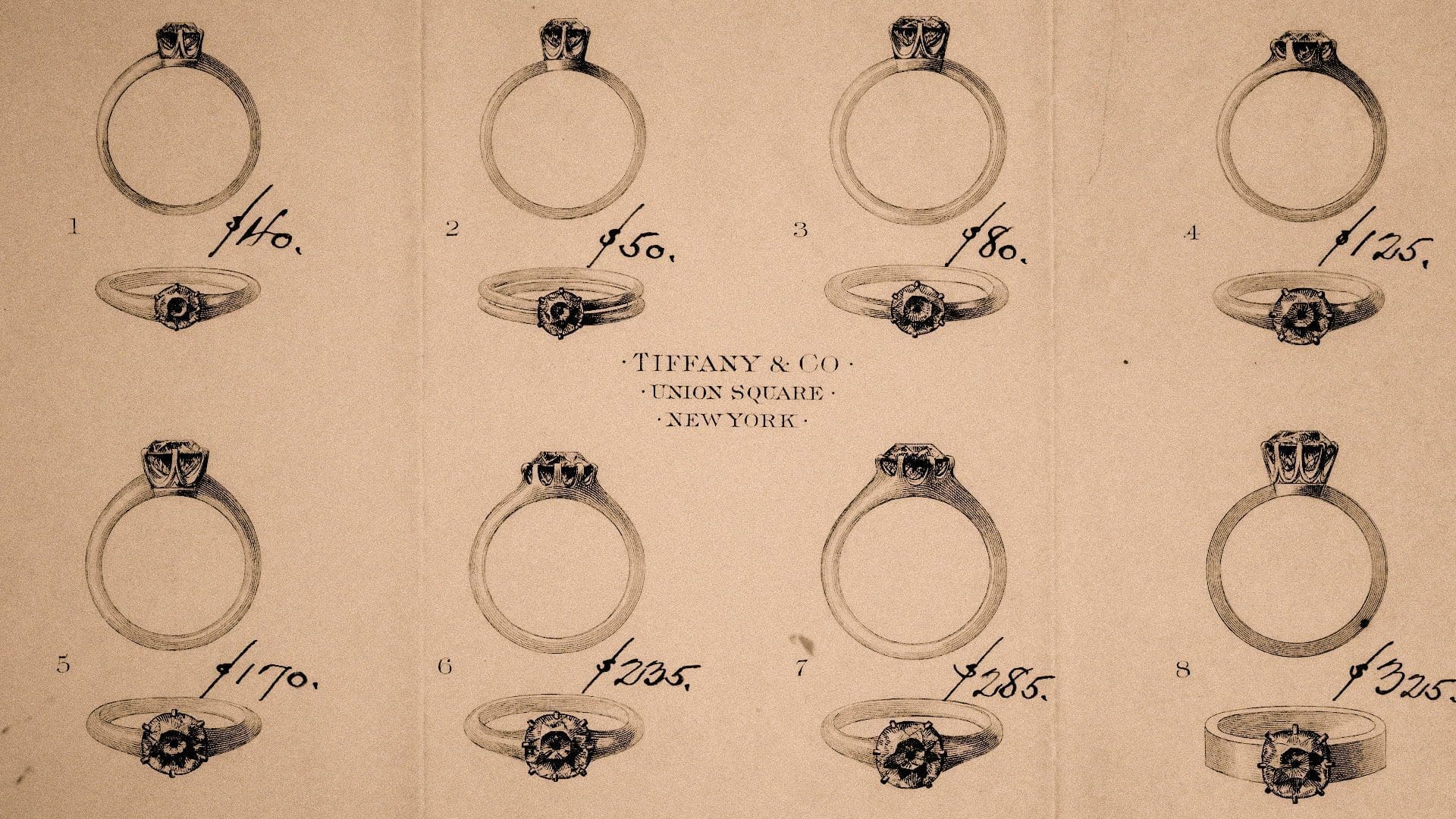 RIOT, NYC Creative Agency: Vintage Tiffany & Co. advertisement showcasing a selection of eight engagement rings with prices, illustrating the classic jewelry styles offered at their Union Square store in New York. Vintage Tiffany & Co. advertisement showcasing a selection of eight engagement rings with prices, illustrating the classic jewelry styles offered at their Union Square store in New York.