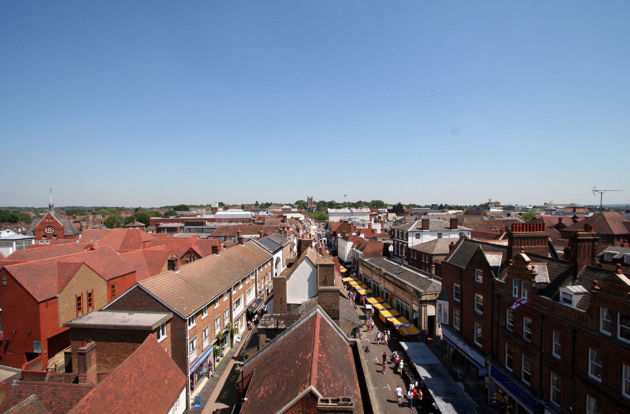 RIOT, NYC Creative Agency: Aerial view of St Albans market from the Clock Tower, showcasing historic buildings and bustling market stalls. Aerial view of St Albans market from the Clock Tower, showcasing historic buildings and bustling market stalls.