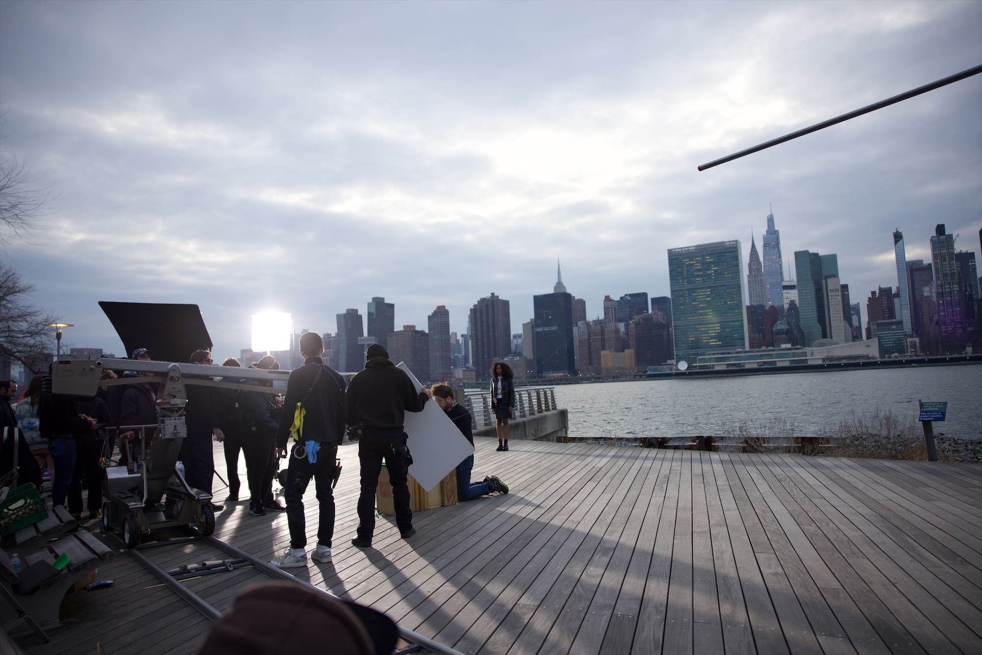 The film crew on the boardwalk with the Manhattan skyline behind