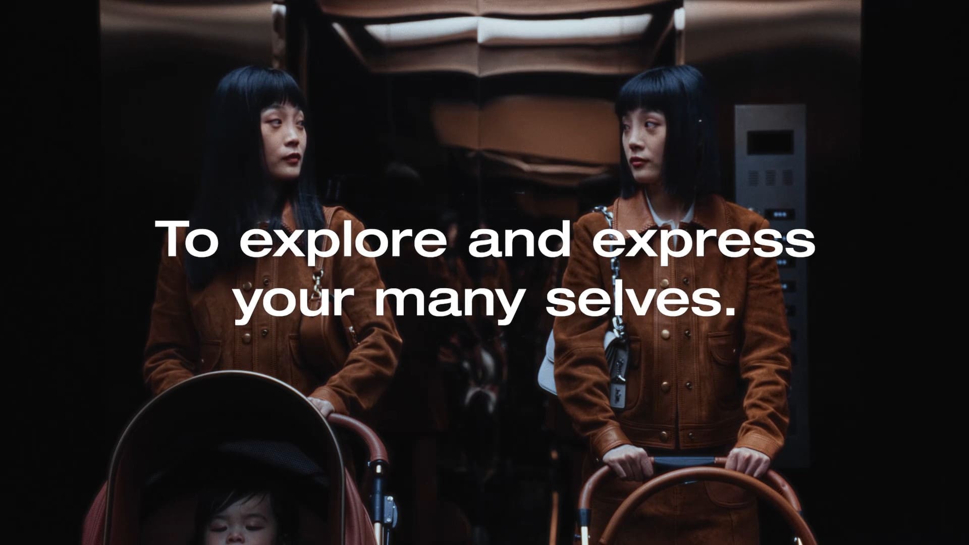 Two women in brown suede jackets pushing prams with the line To explore and express your many selves