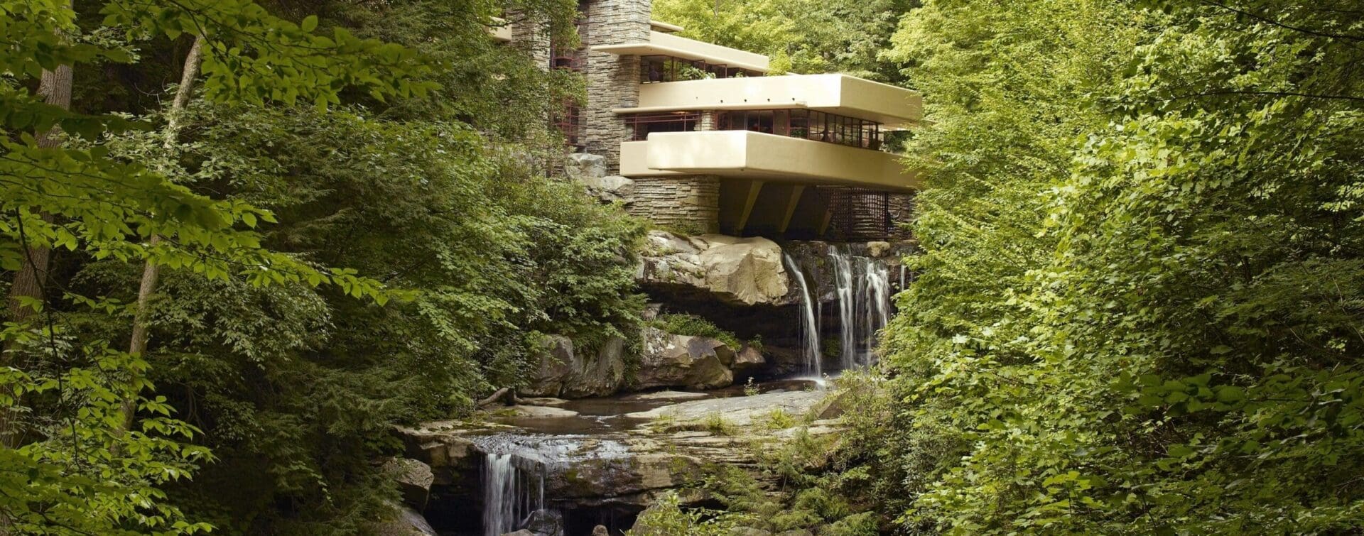 Fallingwater by Frank Lloyd Wright (Photo Taken in 2007) Fallingwater, a house designed by Frank Lloyd Wright, built over a waterfall and surrounded by lush green forest, as seen in 2007.