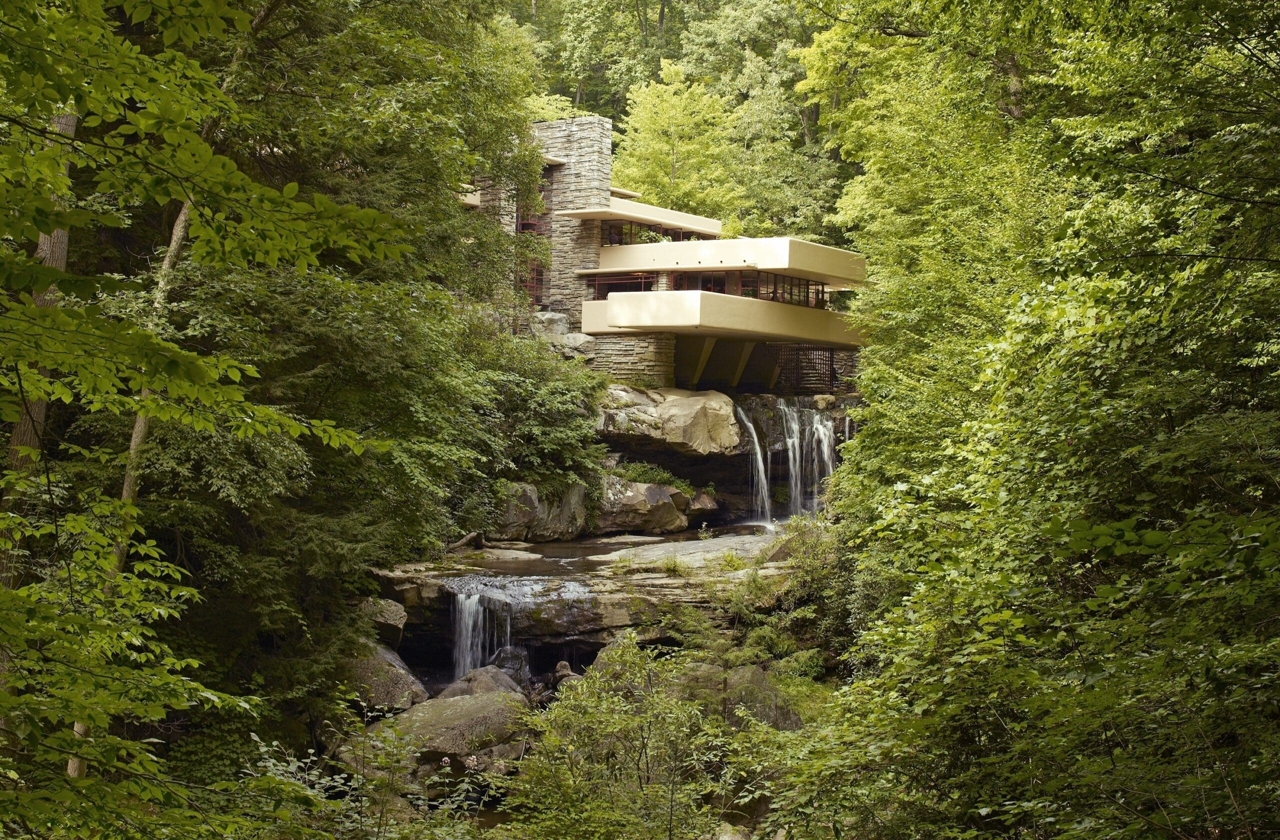 RIOT, NYC Creative Agency: Fallingwater, a house designed by Frank Lloyd Wright, built over a waterfall and surrounded by lush green forest, as seen in 2007. Fallingwater, a house designed by Frank Lloyd Wright, built over a waterfall and surrounded by lush green forest, as seen in 2007.