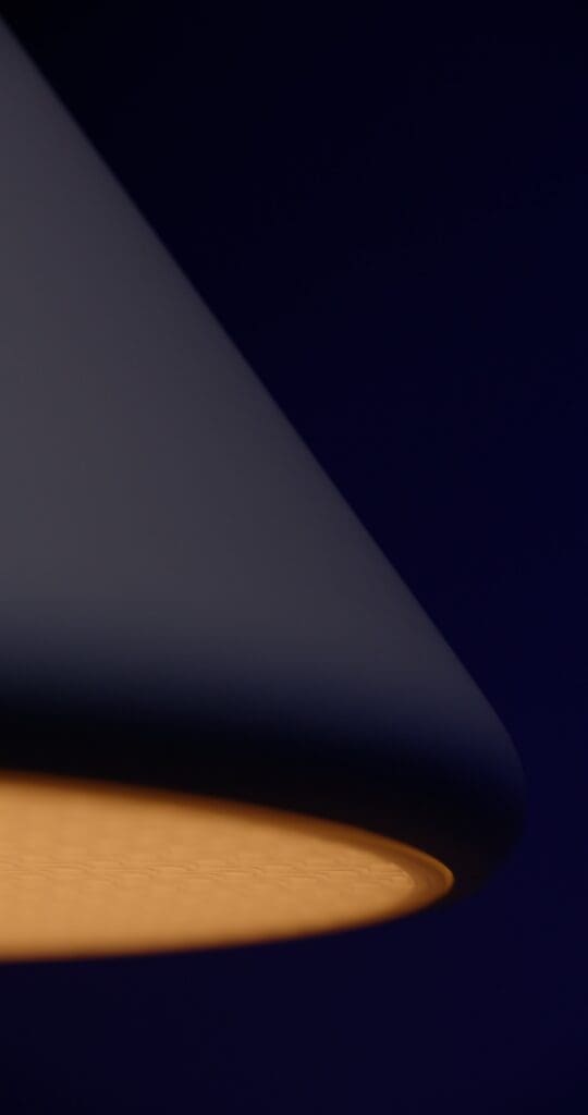 Macro close-up of the Gantri Stack lamp shade edge glowing amber against midnight blue