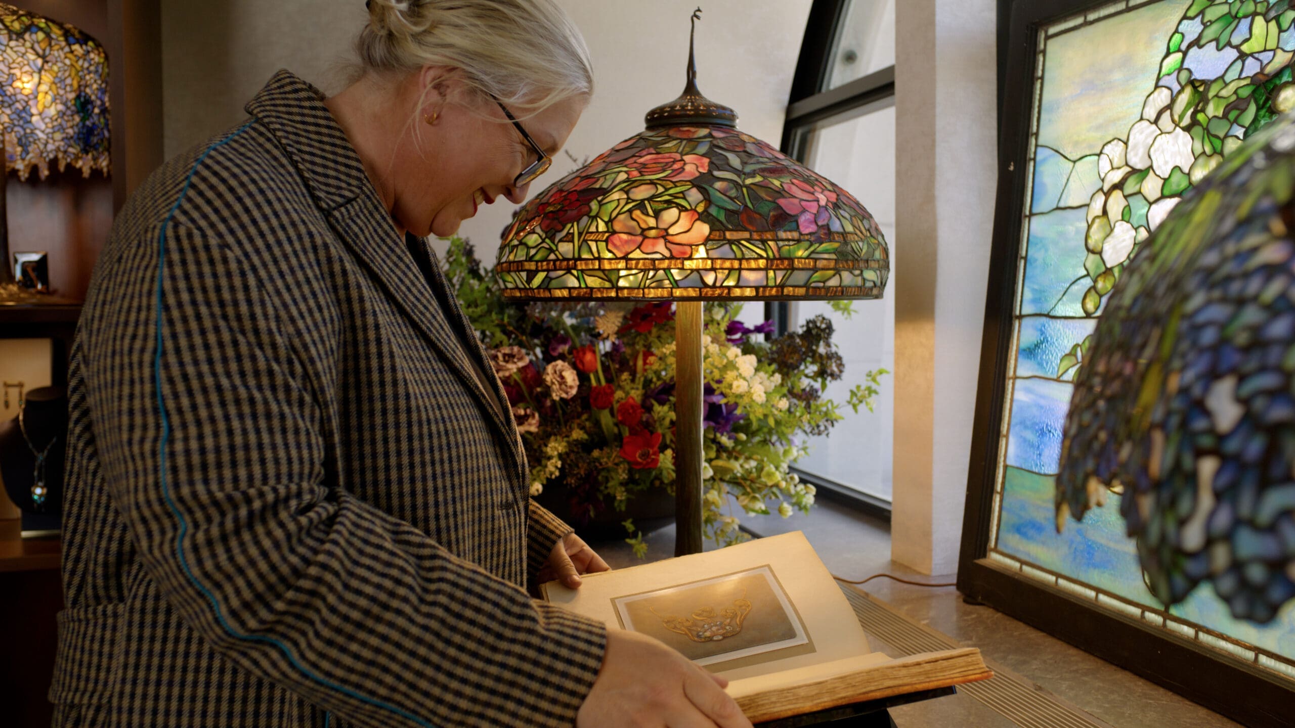 RIOT, NYC Creative Agency: Kate Hawley with Tiffany lamps and reference materials Kate Hawley with Tiffany lamps and reference materials