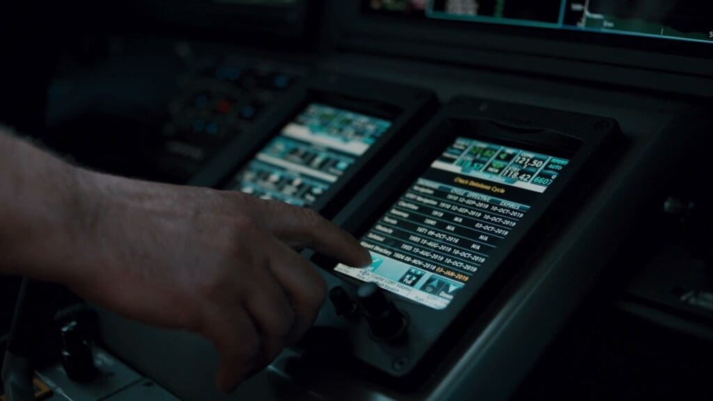A NetJets pilot using the flight deck touch screens