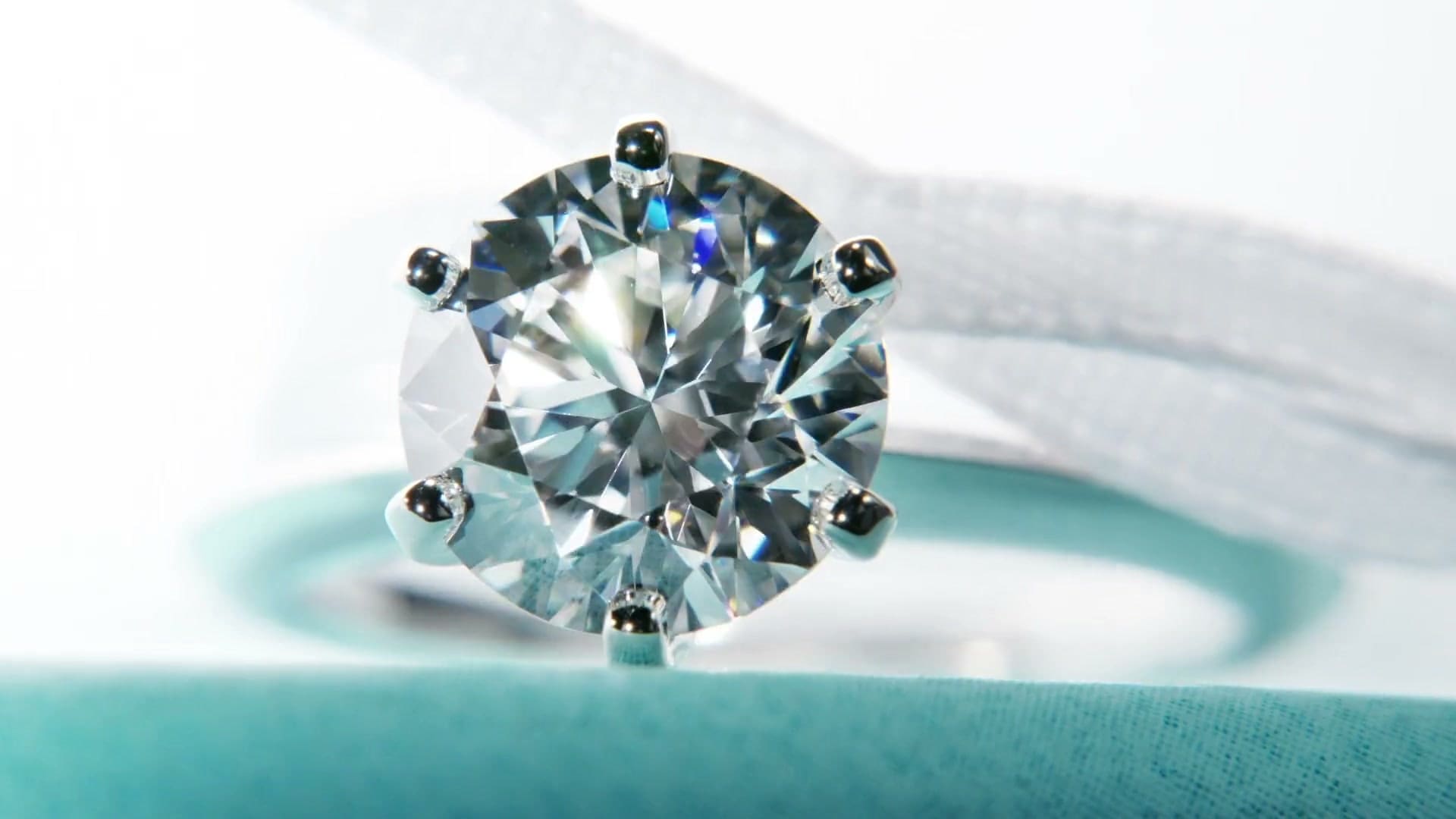 A Tiffany Setting diamond engagement ring on a Tiffany Blue box